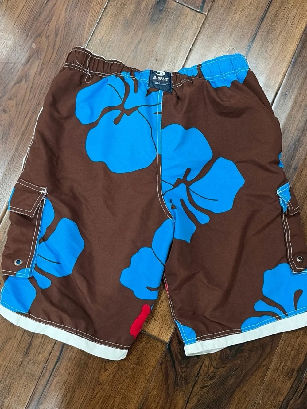 split Brown Swim Board Shorts with Blue Floral and Red Accents